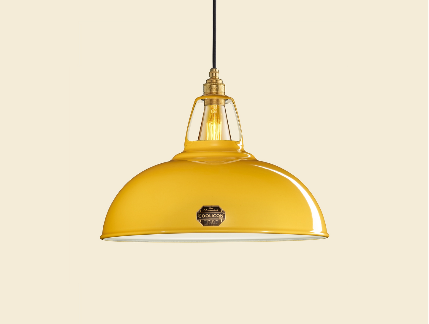 Large Deep Yellow Coolicon lampshade with a Brass pendant set over a yellow background