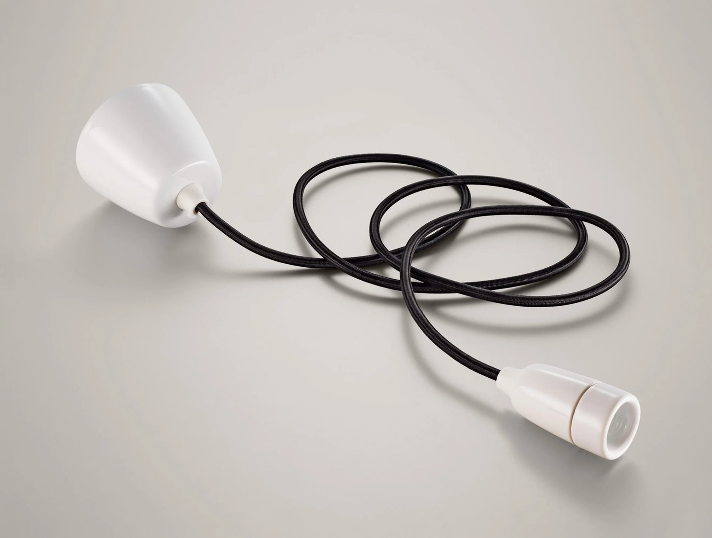 A Coolicon Porcelain pendant set with a white Vitreous Enamel ceiling cup and black cable