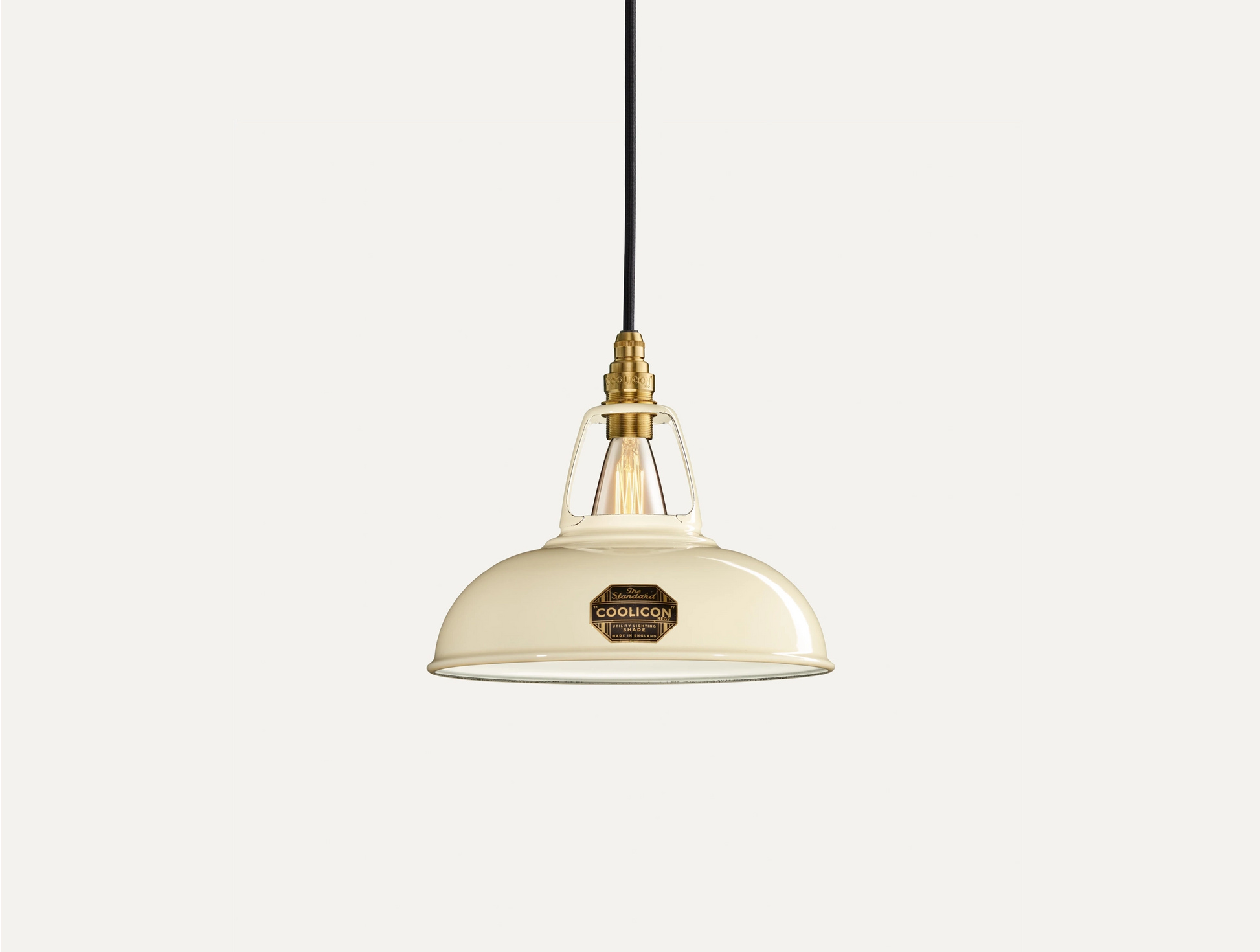 Classic Cream Coolicon lampshade with a Brass pendant set over a light cream background