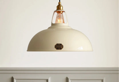A Large Coolicon Classic Cream lampshade hanging in front of a light cream wall with grey moulding