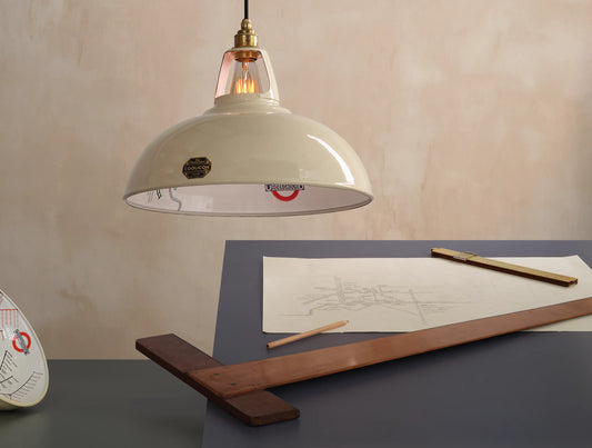 A Large Paper Cream shade over a table. There is a T-square ruler underneath and a pencil sketch of the London Underground map